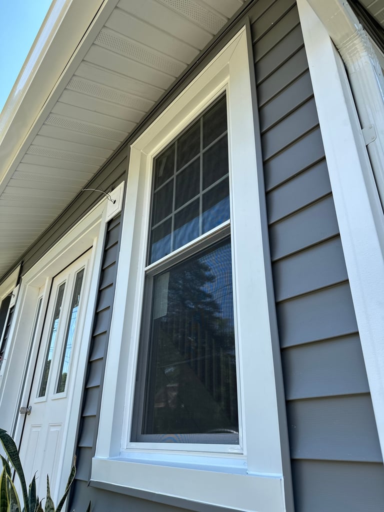Modern house exterior with gray horizontal siding and white trim